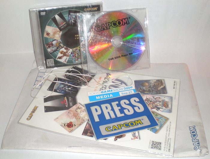 Envelope, public disc, press disc, postcards, and badge
