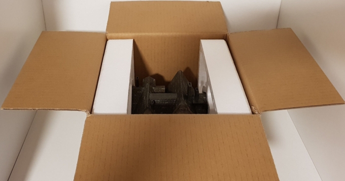 Opened box with mansion replica
